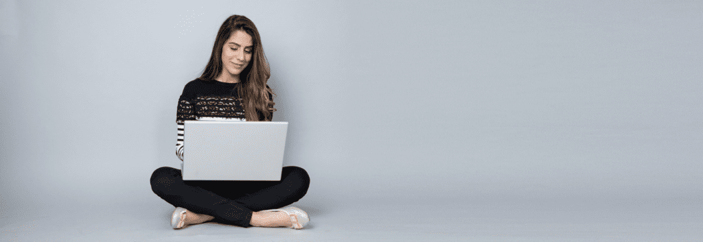 Girl on laptop looking at blogs